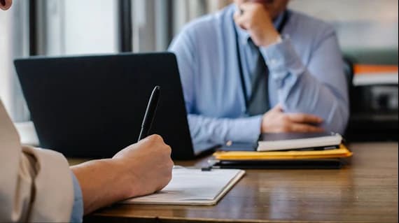 Security analyst reviewing audit activity on a laptop